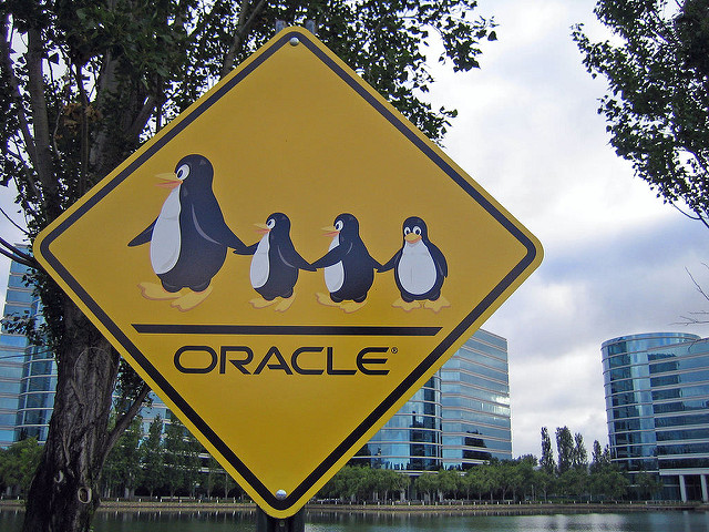 Oracle Linux logo with penguins in a road sign board.